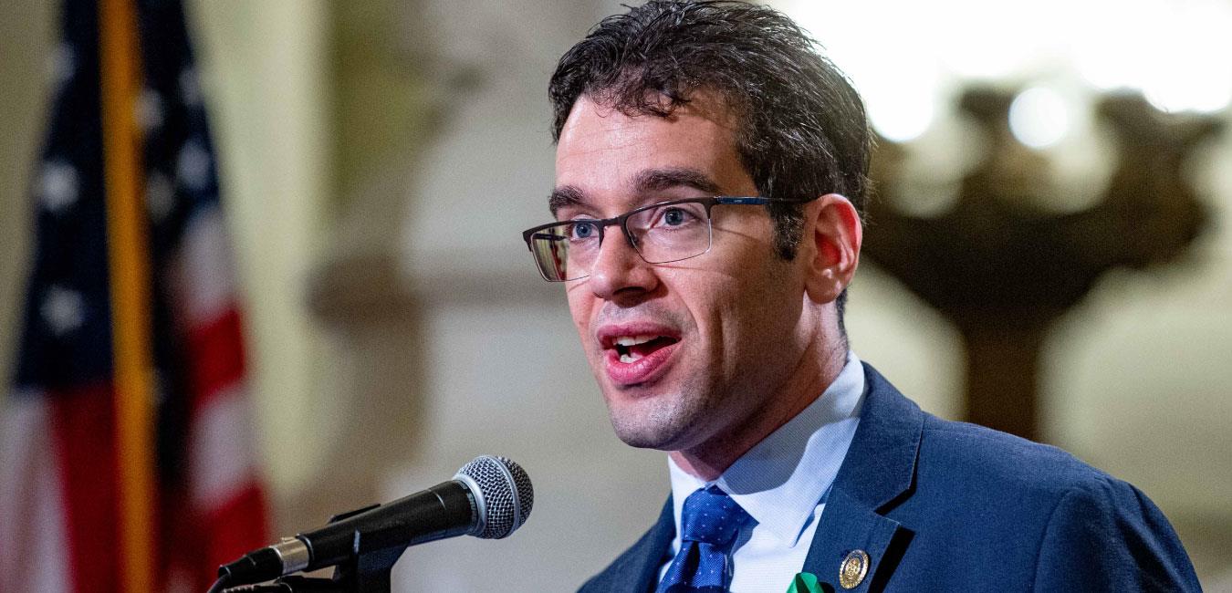 Representative Schlossberg speaking into microphone