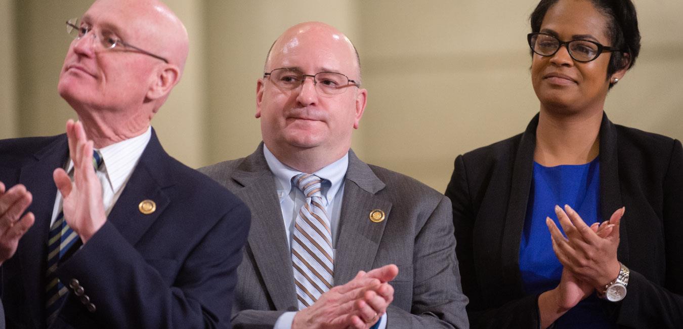 Representative Sanchez applauding next to fellow lawmakers