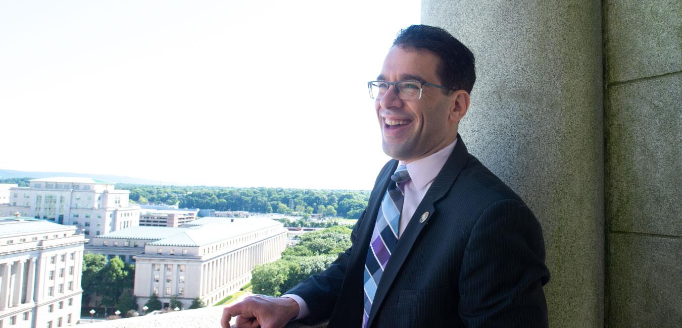 Representative Schlossberg smiling and looking off camera on balcony of Capitol building