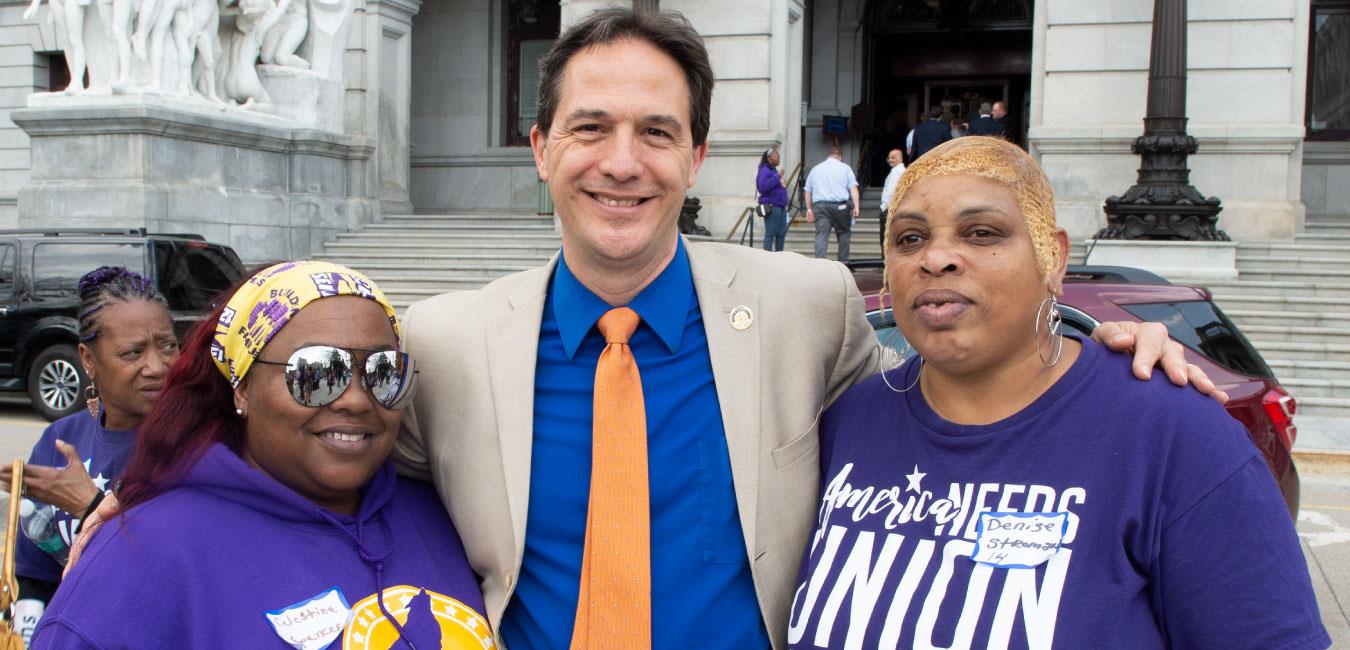 Representative Hohenstein posing for photo with two women union members in front of the Capitol