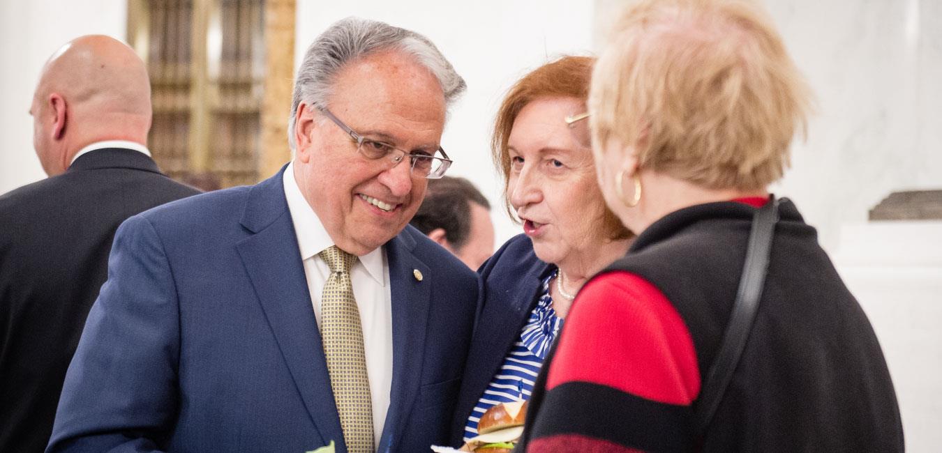 Representative Pashinski smiling and speaking with two elderly women