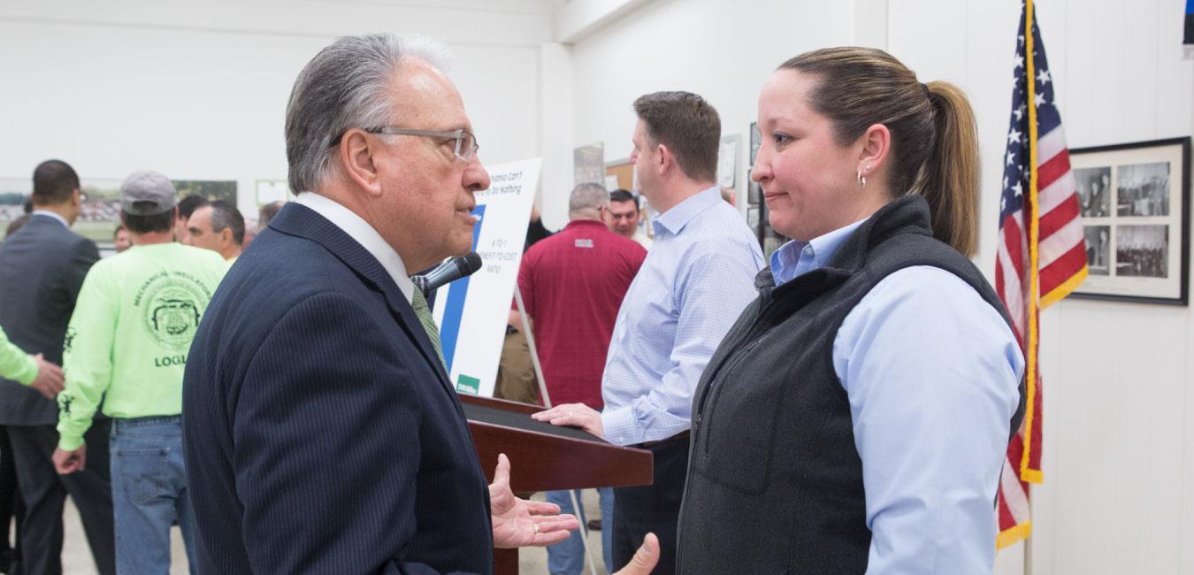 Representative Pashinski having a conversation with woman at indoor event