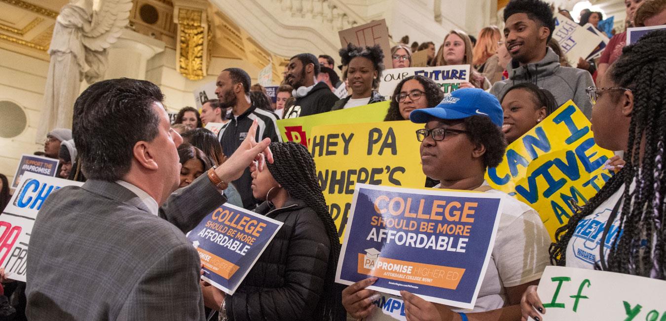 Representative Ciresi addressing affordable college advocates standing on Capitol rotunda steps