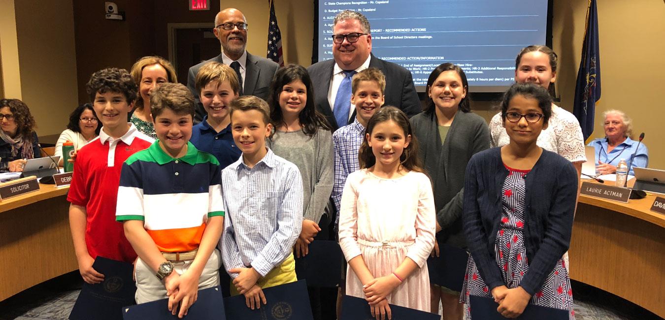 Representative Briggs posing for photo with group of students