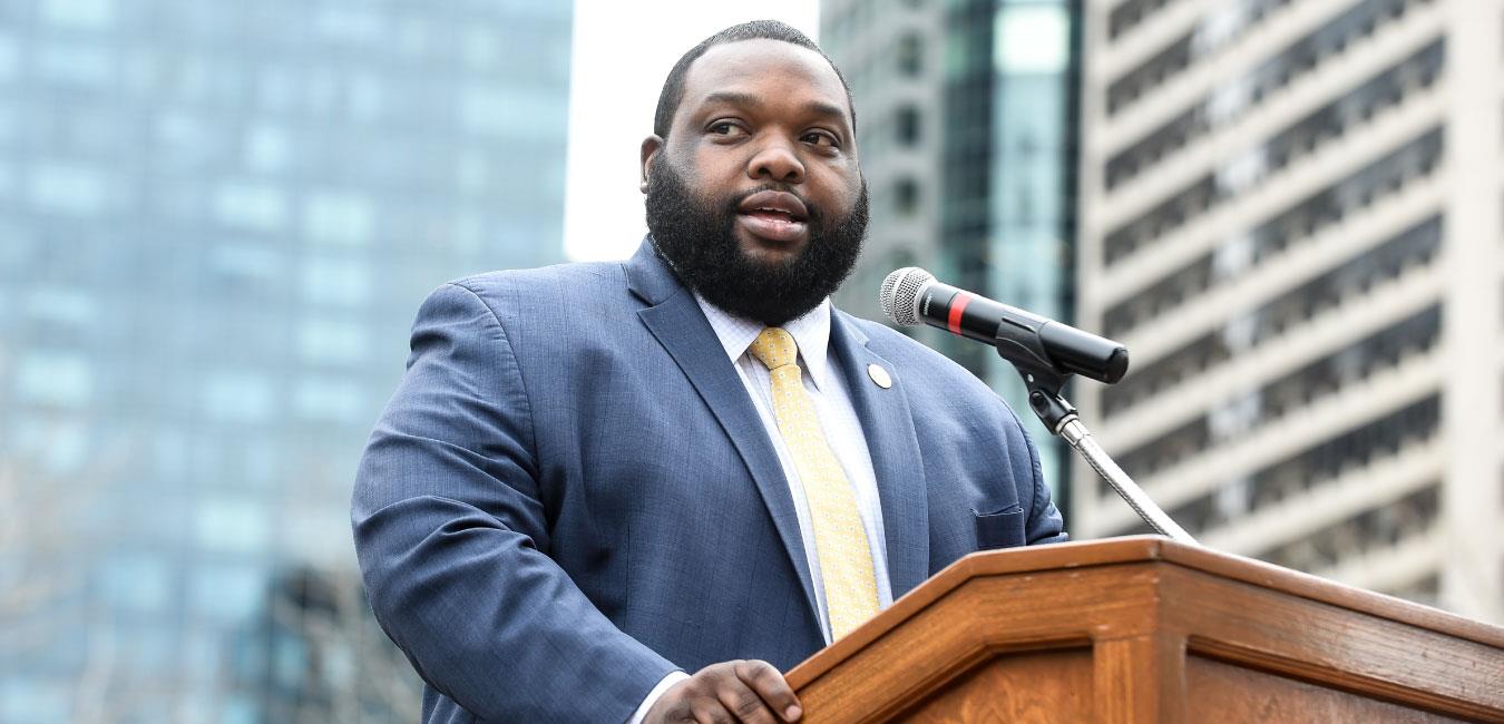 Representative Harris speaking at podium outside in Center City Philadelphia