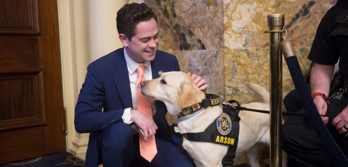 Representative Mullins petting K-9 police dog on House floor